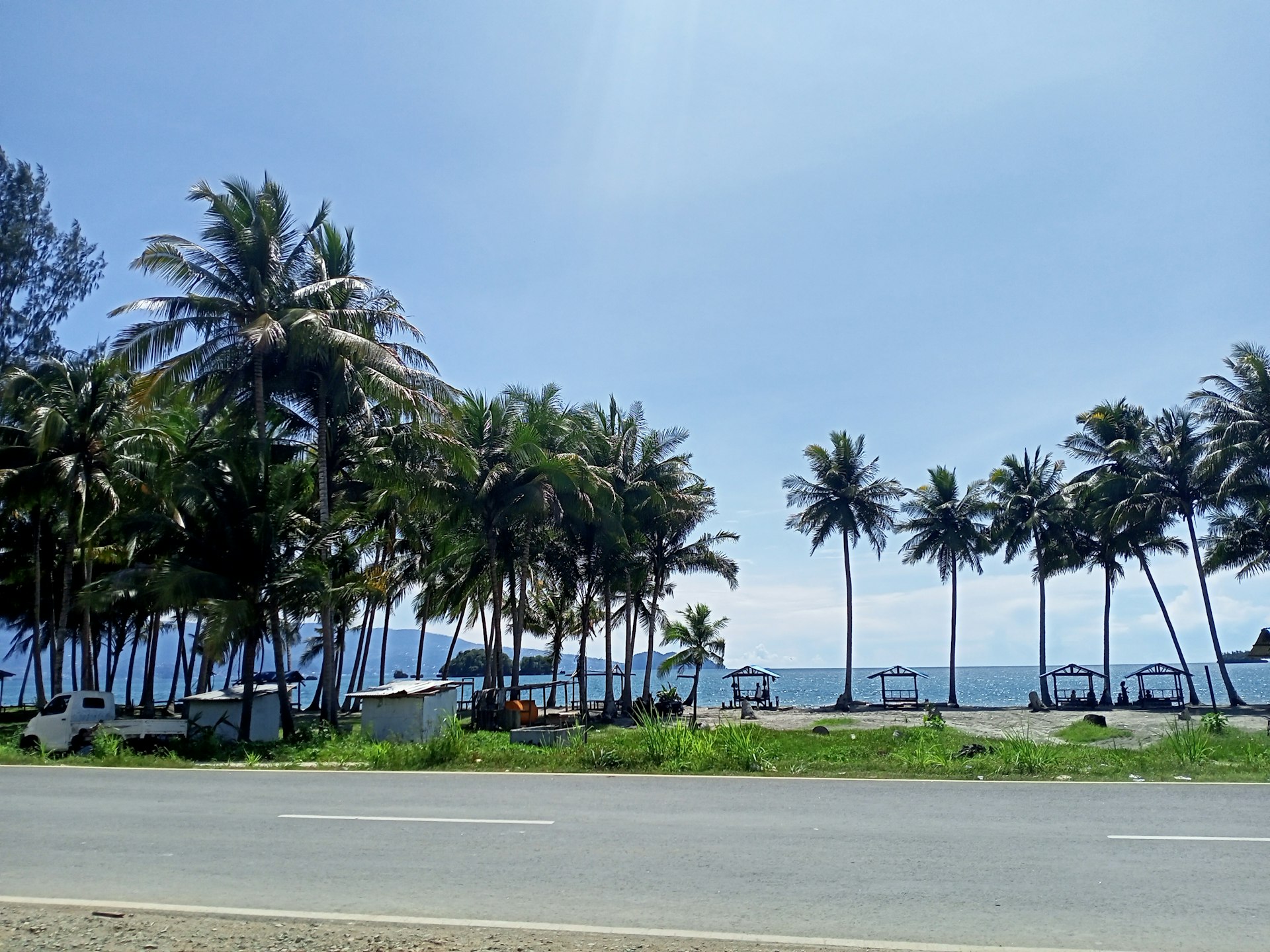 Nungwi Beach view - Nile Abenteuer Safaris things to do in Zanzibar Palm trees line the side of a road near the ocean